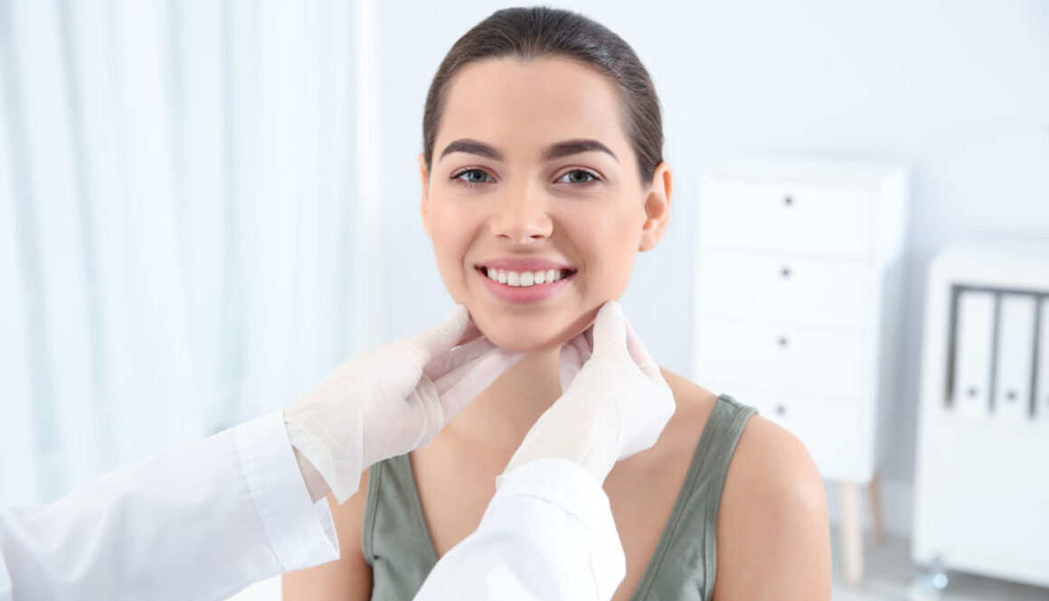 Dermatologist examining patient's face in clinic. Skin cancer checkup