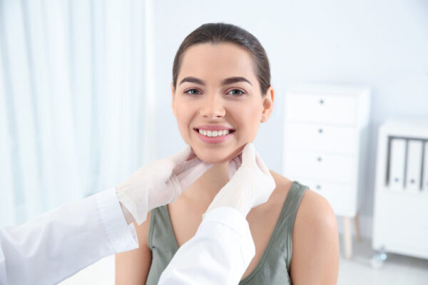 Dermatologist examining patient's face in clinic. Skin cancer checkup